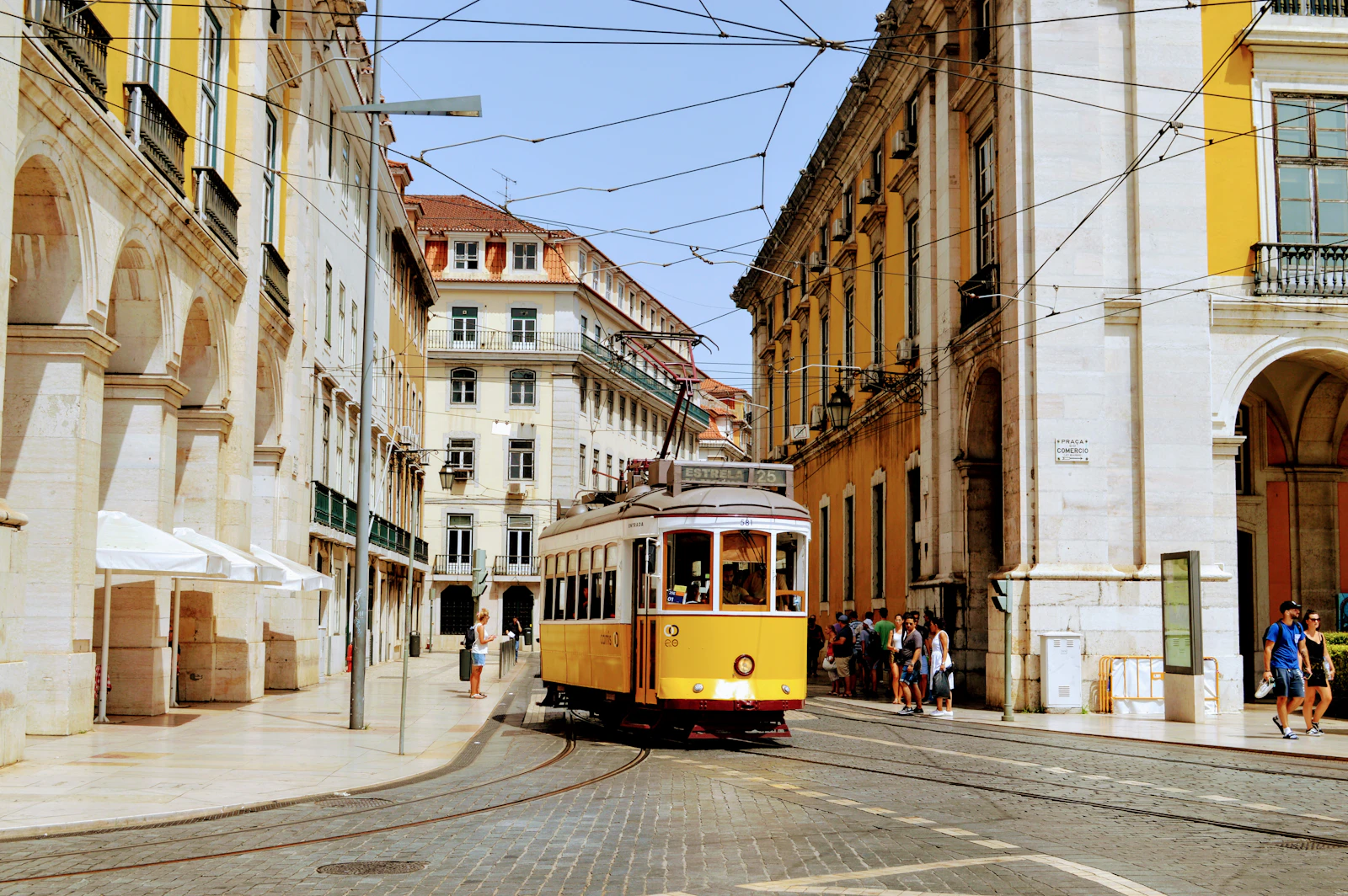 A yellow tram on a Lisbon street